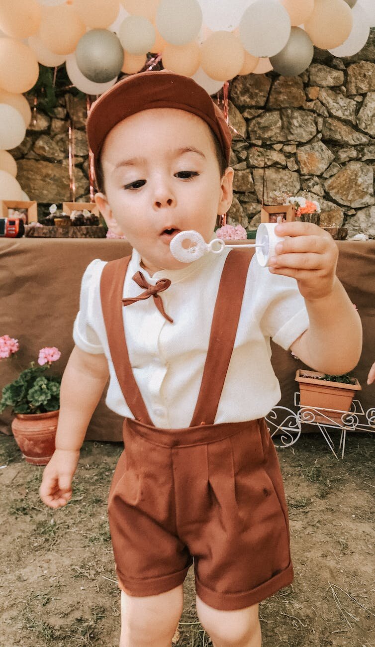 cute boy blowing bubbles during holiday